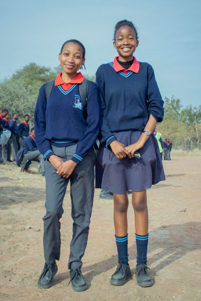 Two gold-youth Peer Educators in school uniform
